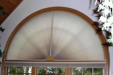 Movable Arch Honeycomb Shades providing complete light control